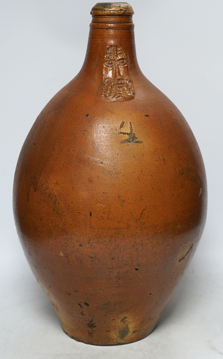 An 18th century German large salt glazed Bellarmine, 45cm. Condition - commensurate with age